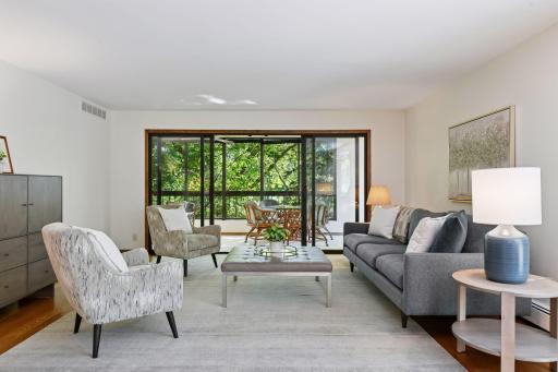Photo for 7250 Lewis Ridge Parkway, 107, Minneapolis, MN 55439 - listing #6794217 Right off the living room is an expansive sunroom with double sliding glass doors surrounded by trees and privacy