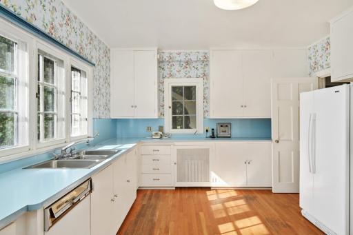 The spacious efficient original kitchen has several west facing windows