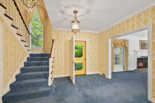 The large welcoming foyer features a grand turned staircase with a stunning Palladian window and opens to the immense formal entertaining rooms.
