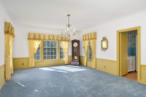The palatial formal dining room is excellent for beautiful dinner parties or holiday gatherings and features a picture window overlooking the vast yard.