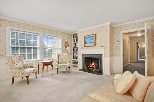 The primary suite features a lovely sitting room/office featuring a fireplace with the federal mantle and wainscoting.