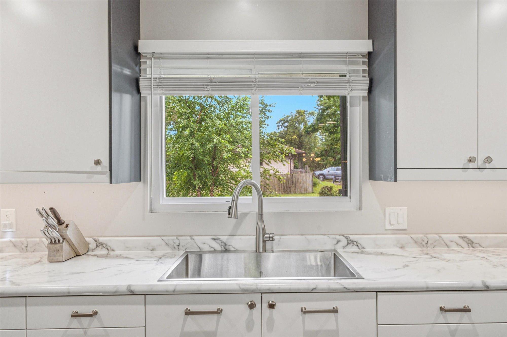 Enjoy peaceful backyard views from the kitchen sink.