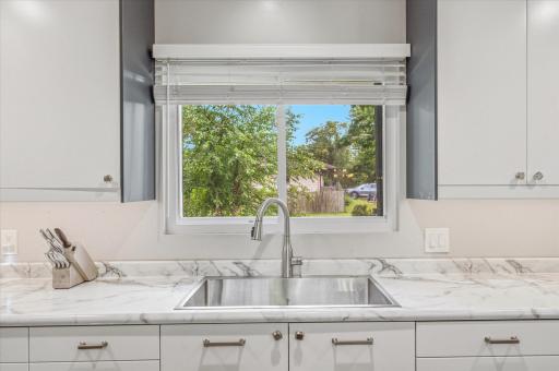 Enjoy peaceful backyard views from the kitchen sink.