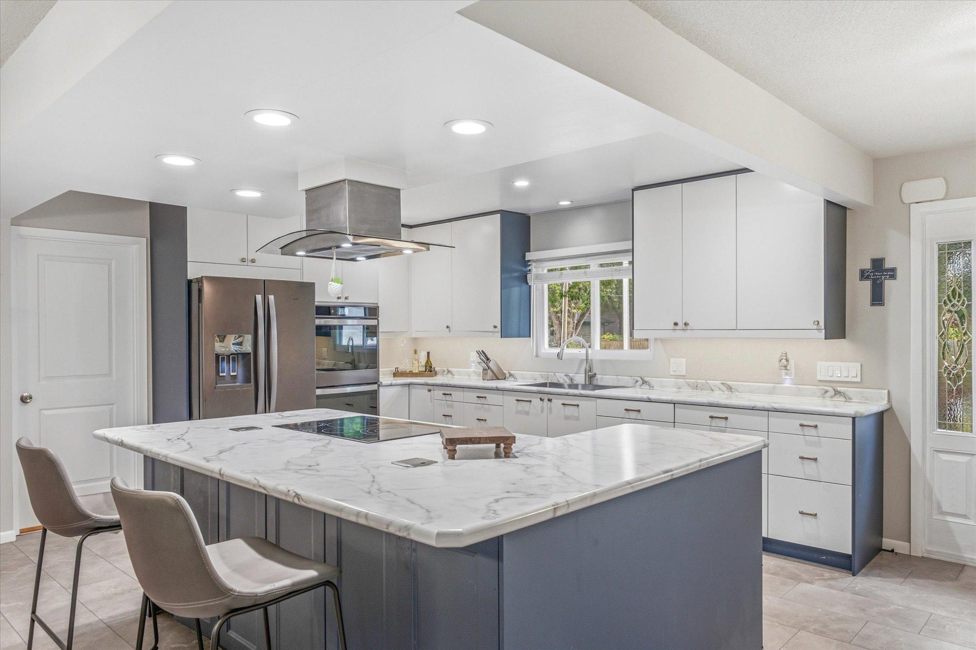 The beautifully remodeled kitchen features a stunning oversized center island.