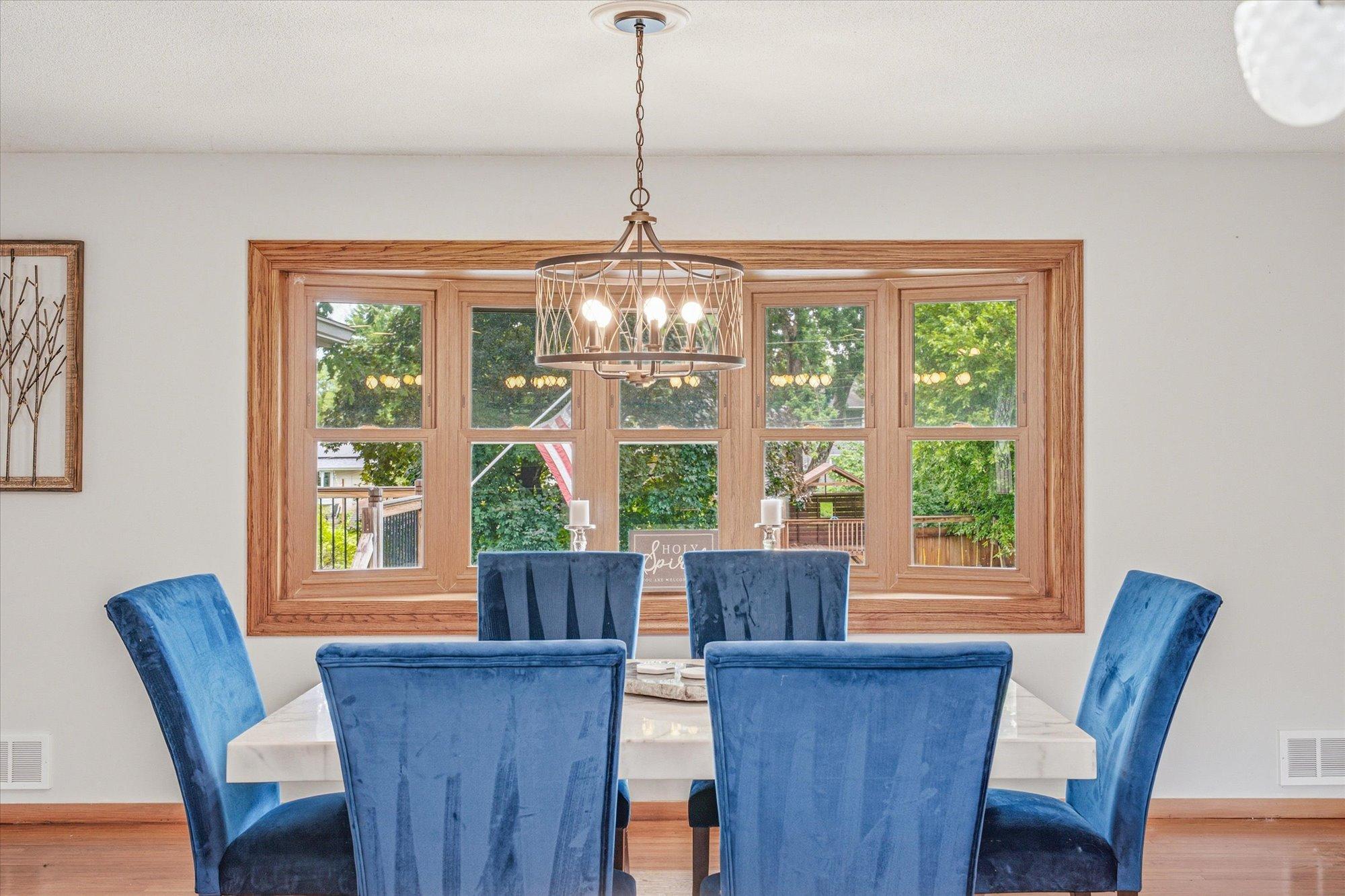 Large windows fill the dining room with natural light.