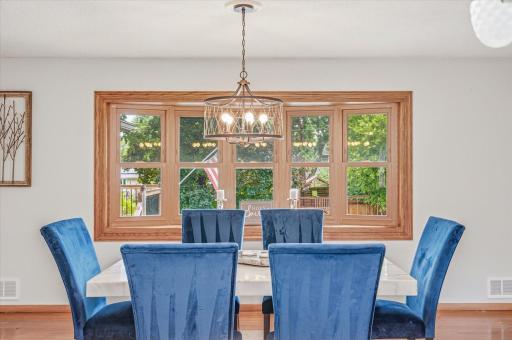 Large windows fill the dining room with natural light.