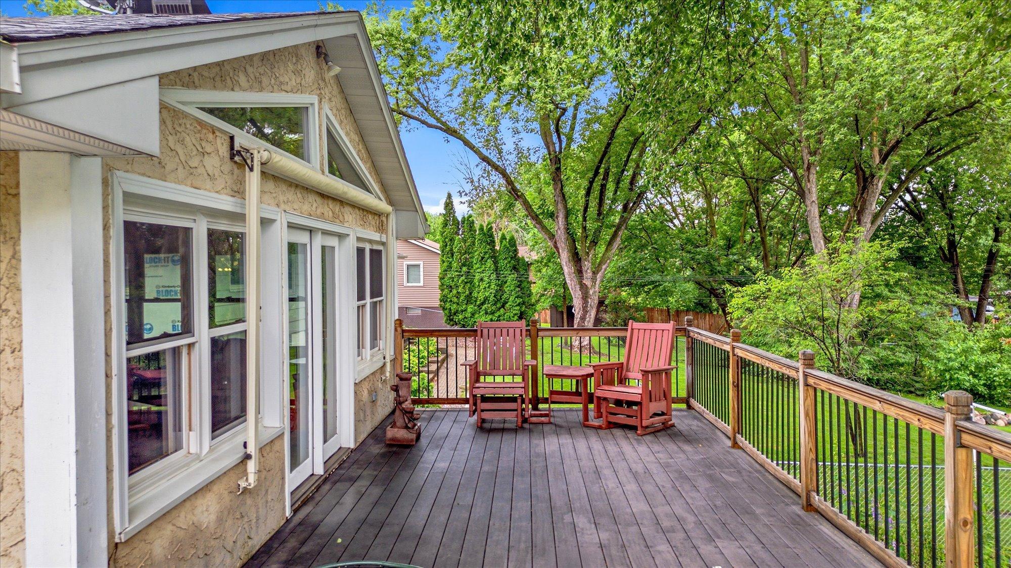 The expansive deck overlooks the pool and beautifully landscaped yard.