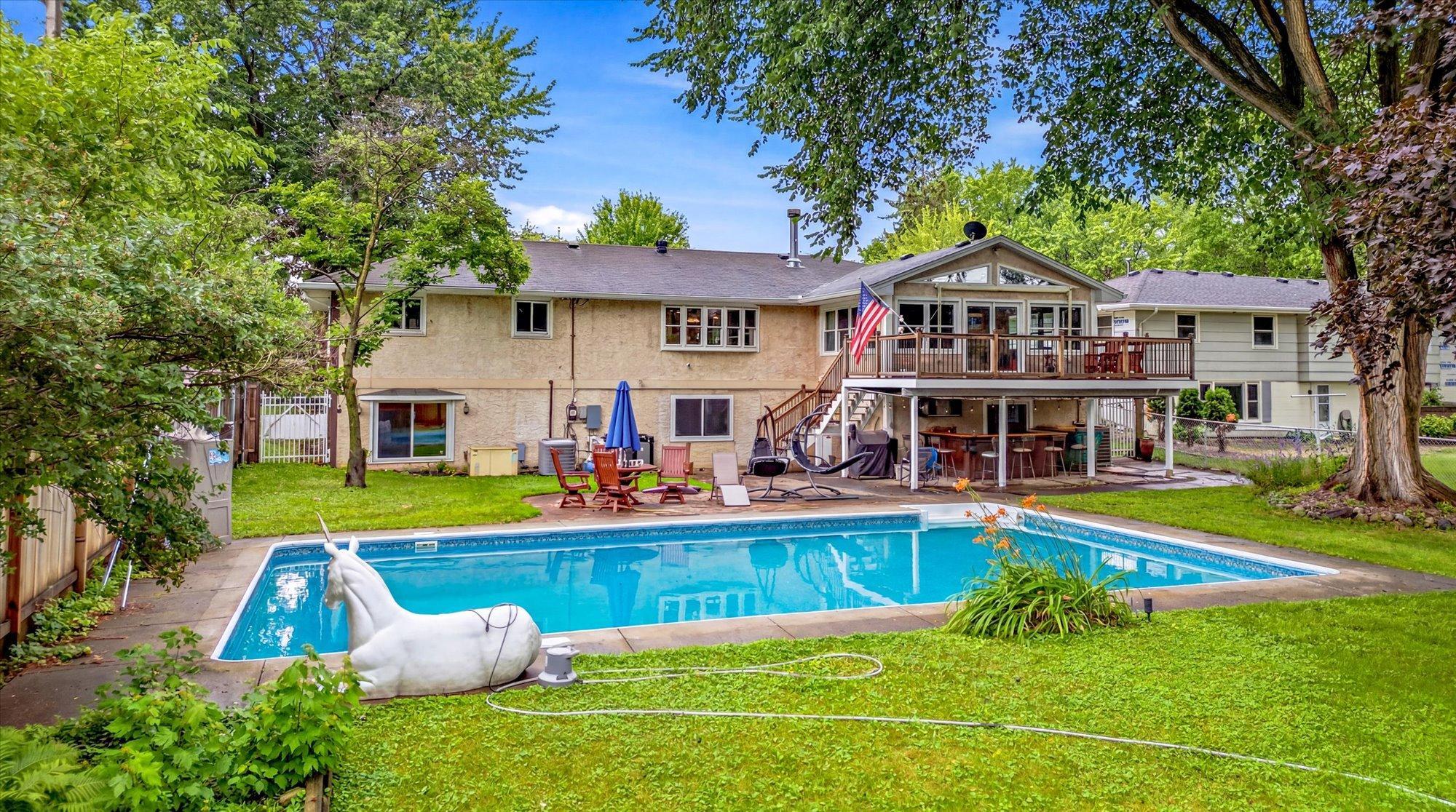 The backyard is truly a private resort with an in-ground pool and multiple outdoor living spaces.
