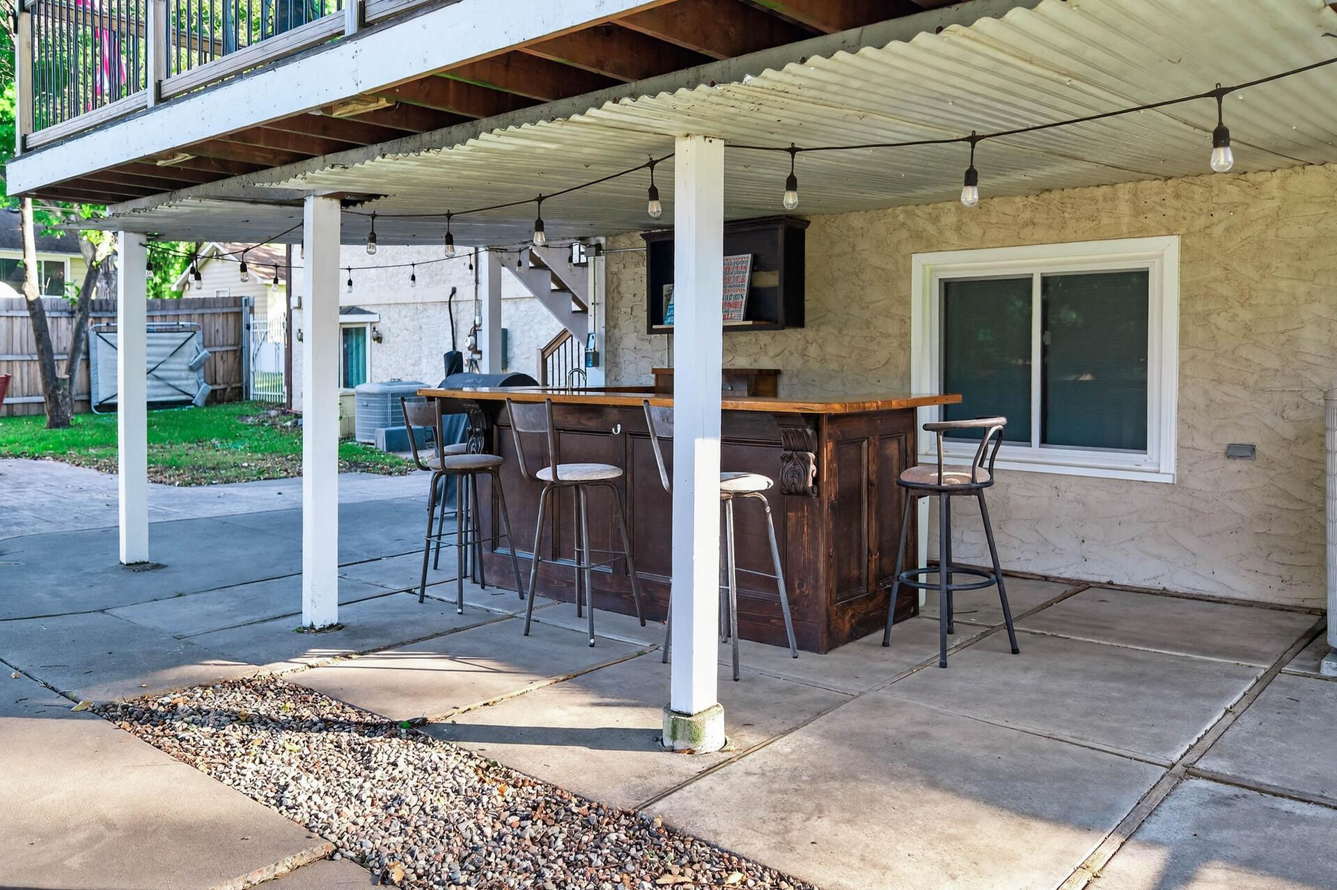 The covered outdoor bar is ready for your next gathering.