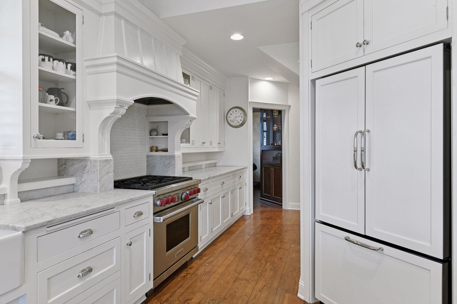The Kitchen is equipped with professional appliances from Wolf, KitchenAid and Bosch. - Tucked away behind the refrigerator is a walk-in pantry providing ample storage.