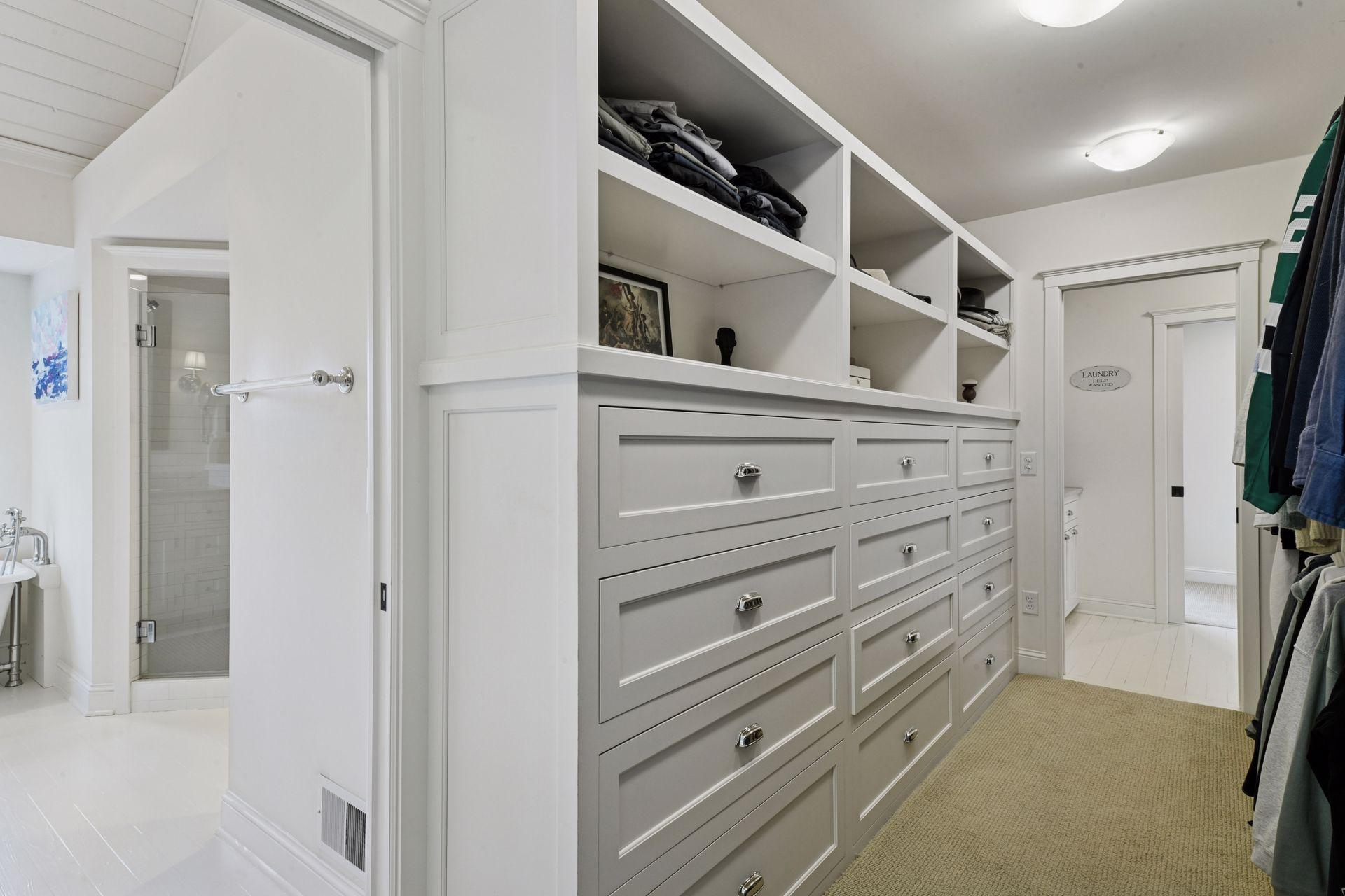 Step through to the walk-in closet which features extensive built-ins including a window bench.