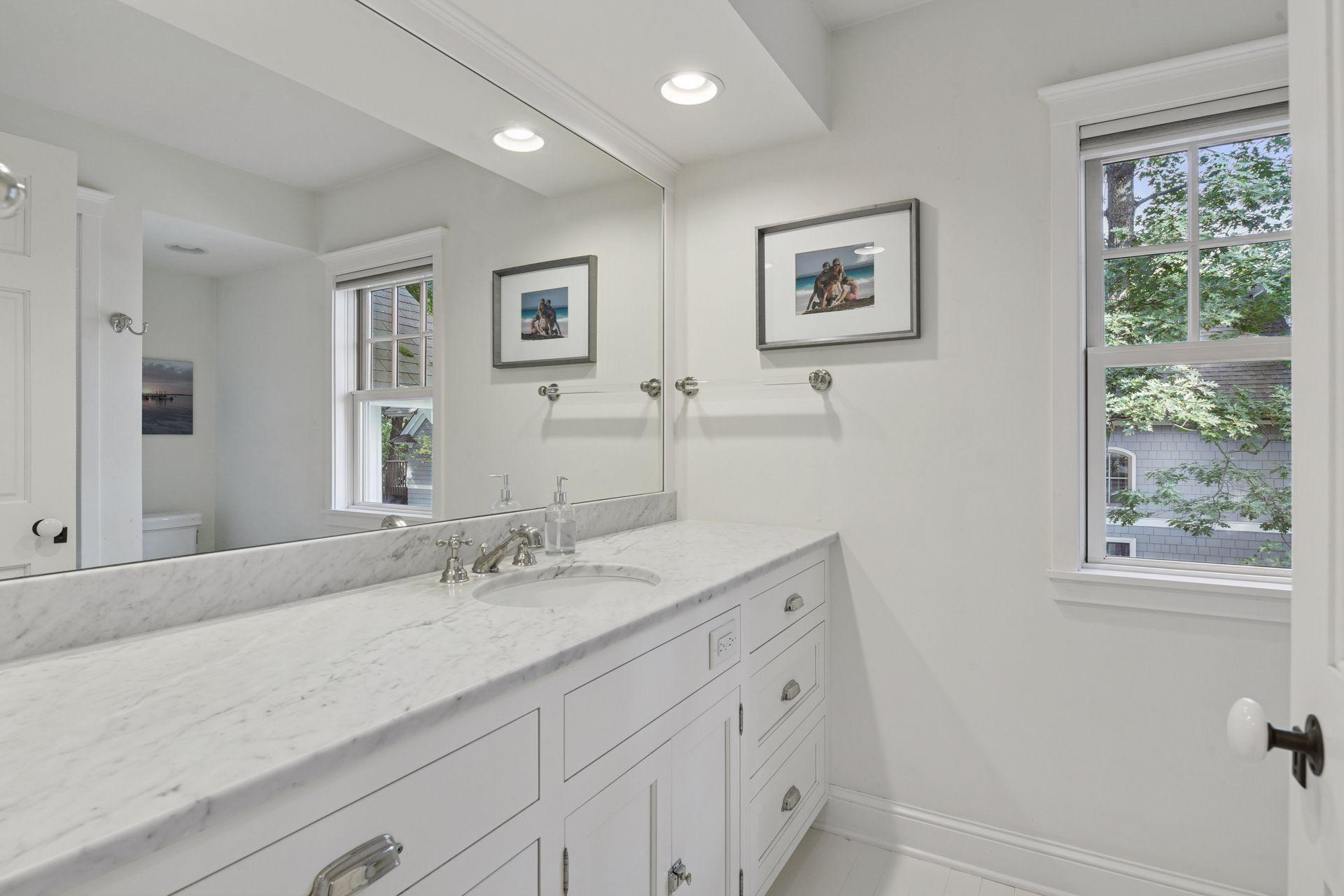 The upper level 3/4 Bathroom features a comfort height vanity with marble countertops.