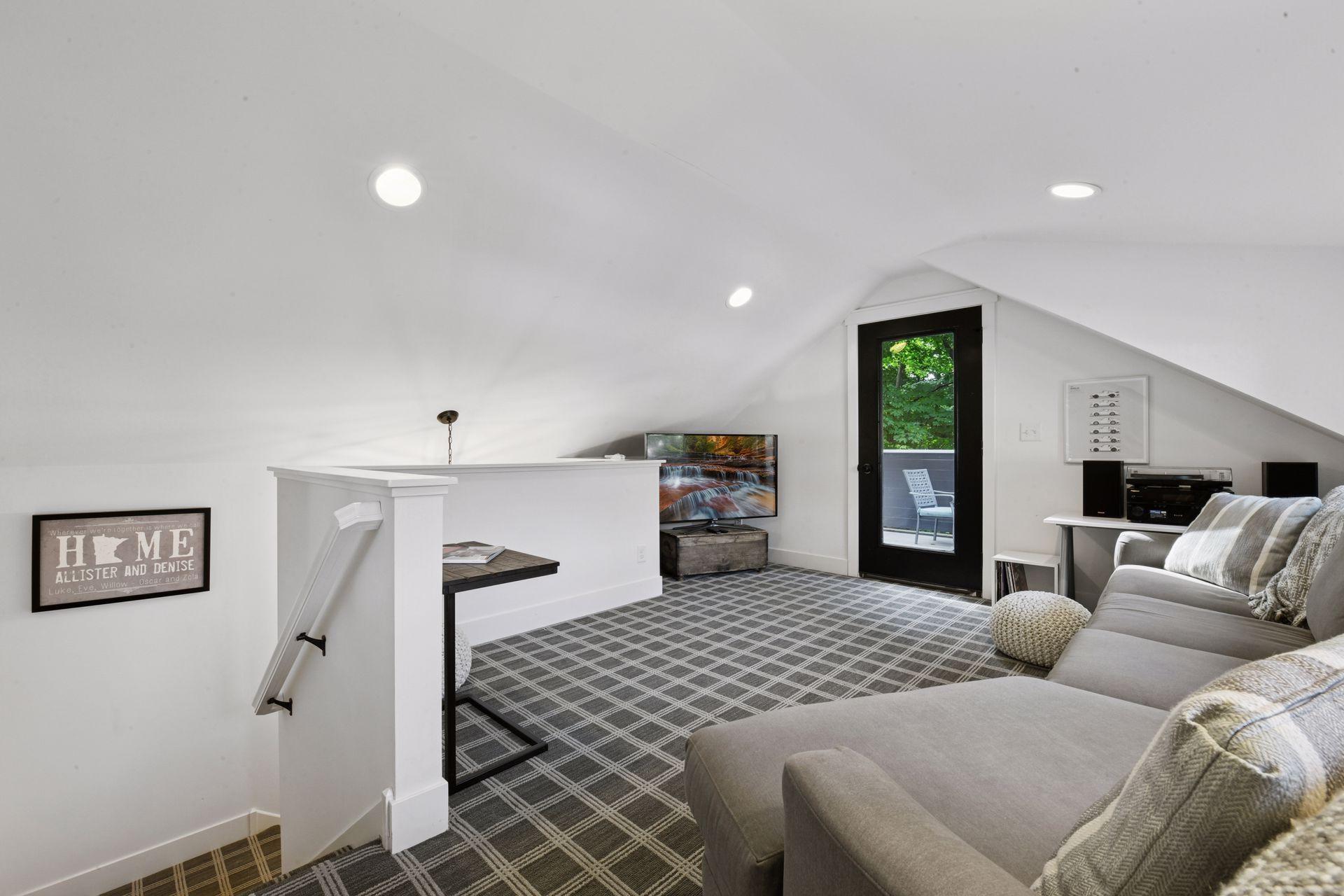 Designer carpeting leads you upstairs to the second living space - the City of Deephaven allows for plumbing to be added to the building for a future bathroom.