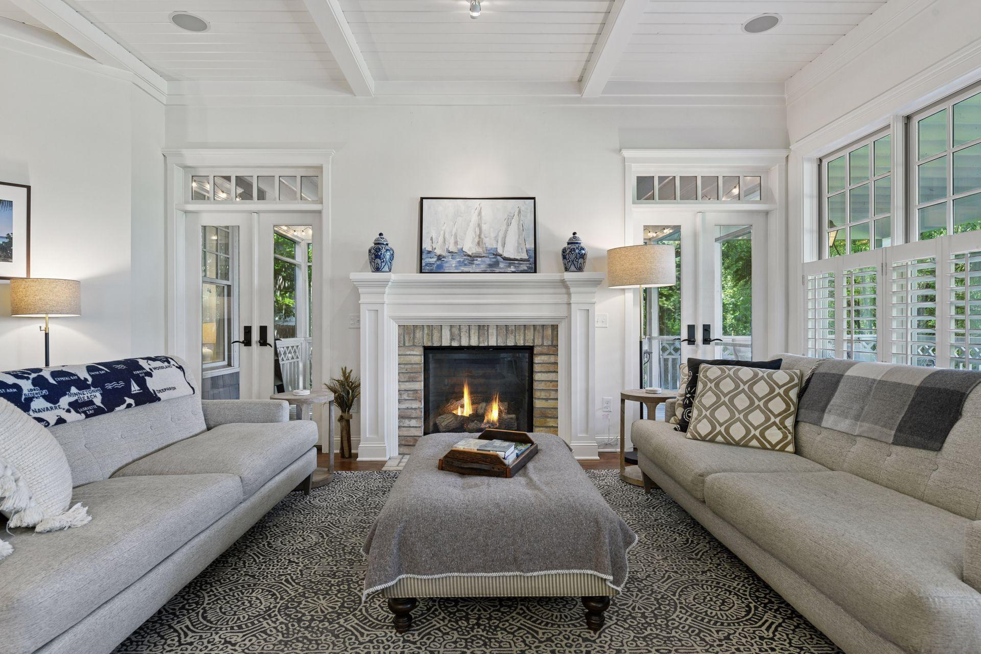 The focal point of the Family Room is an inviting gas fireplace flanked by French doors that lead out to the screen porch.