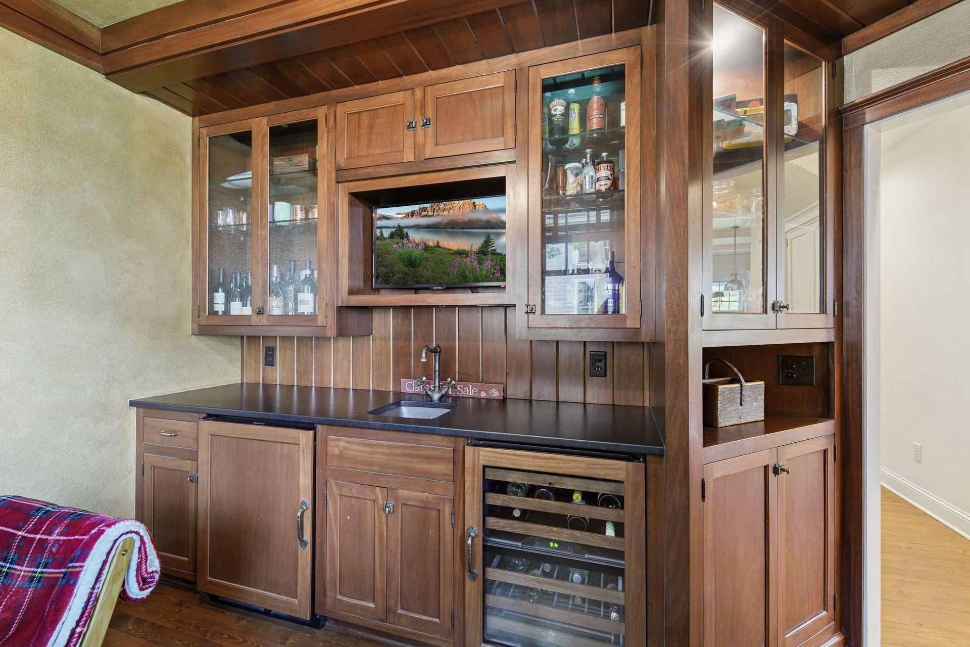 The Flex Room features a well-appointed wet bar with a wine chiller and beverage refrigerator. This is the perfect space for a quiet home office or bar room!