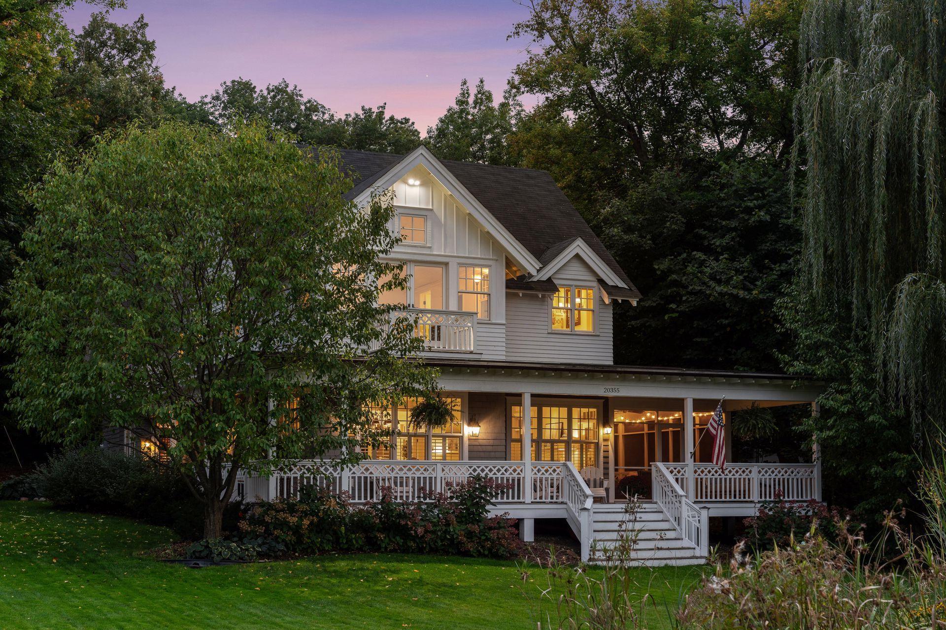 A warm and inviting home nestled in a storybook setting, where timeless charm meets everyday comfort.