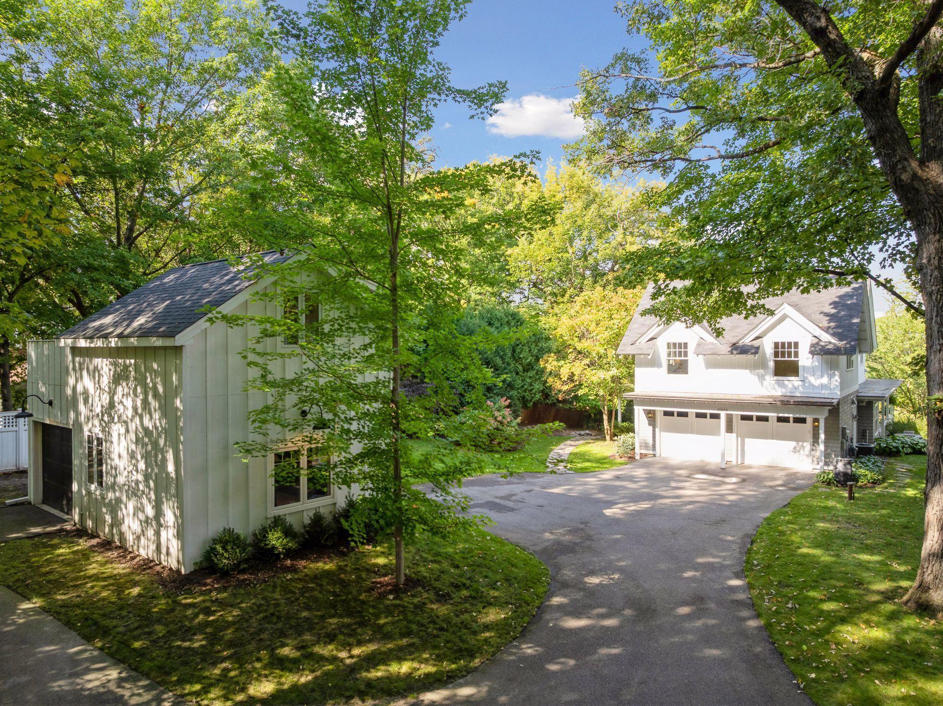 Situated on a half-acre lot surrounded by towering trees and cascading willows, this is a serene and private setting.