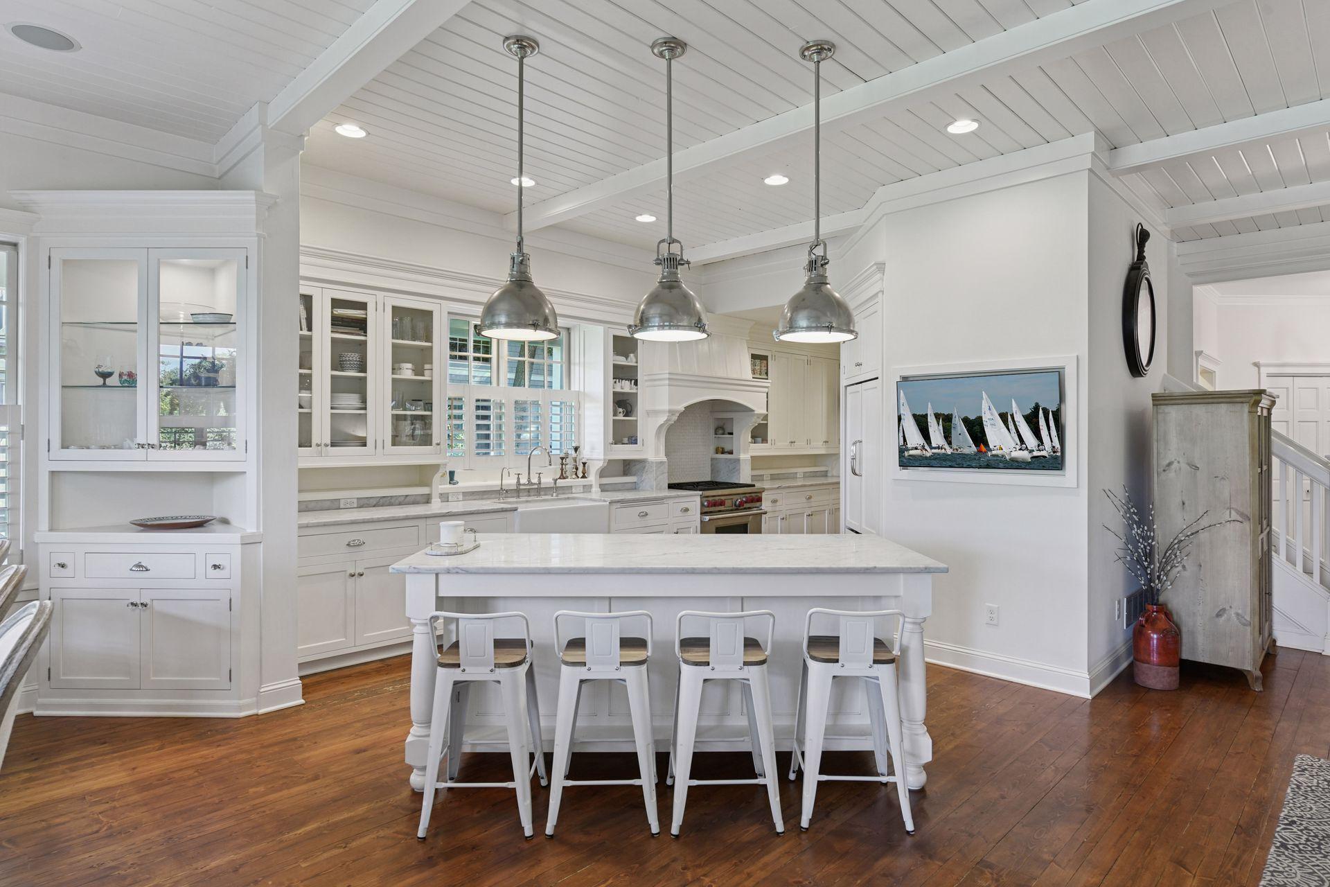The gourmet Kitchen features custom cabinetry and classic marble countertops.