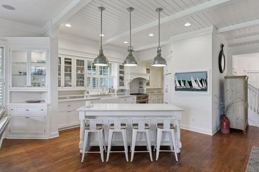 The gourmet Kitchen features custom cabinetry and classic marble countertops.