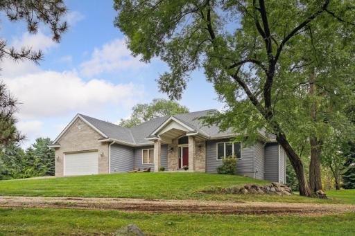 Executive style rambler sits on over 2 acres of wooded serenity.