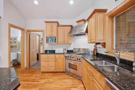 The main level half bath and oversized laundry room with a walk in pantry are conveniently located next to the kitchen.