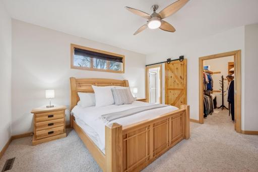 The sliding barn door adds a rustic feel to this lakeside retreat.
