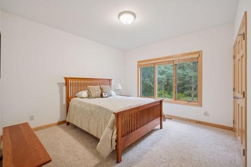 The main level guest room features neutral finishes and a large closet.