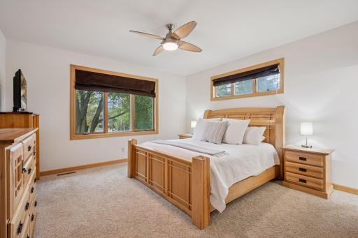 Tranquil primary bedroom with peaceful views of the lake.