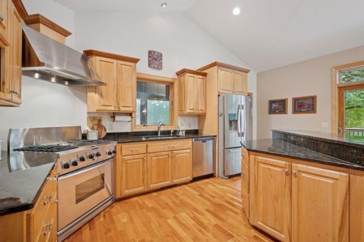 Generous kitchen layout with windows on each side letting all the natural sunlight in.
