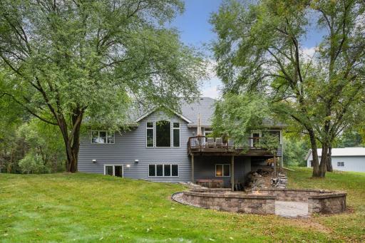 Mature trees surround the property at every angle.