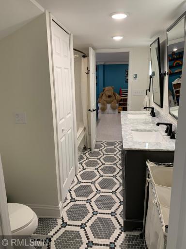 Lower level jack and jill bathroom with custom tile and heated floor