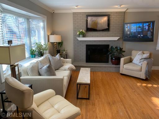 Living room with gas fireplace, TV wall mount that swings to dining room and kitchen