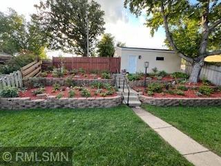 Tiered gardens leading up to garage