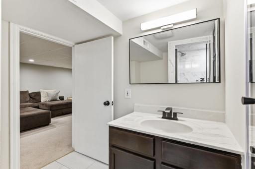 Additional view of the lower-level bathroom, highlighting clean finishes and a functional layout.