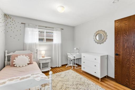 Bedroom with hardwood floors, neutral finishes, and a functional layout that can easily adapt as a guest room, office, or additional living space.
