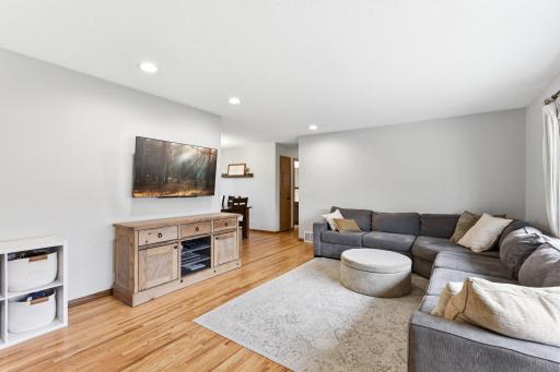 Open main living area with clear sightlines from the entry, showcasing hardwood floors and an easy flow into the rest of the home.