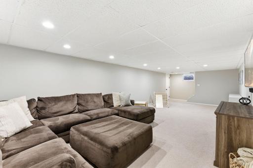 Additional view of the lower level, highlighting the space's size and versatility for everyday living or entertaining.