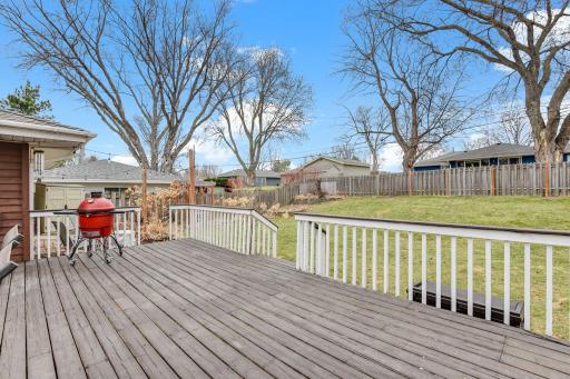 Elevated deck overlooking the backyard, offering a great vantage point for relaxing or hosting.