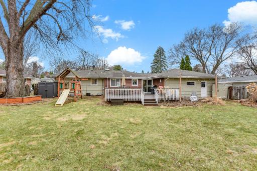 Full view of the homeâs rear exterior showcasing the deck and backyard layout.