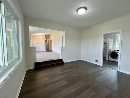 Sitting room looking at living room and laundry