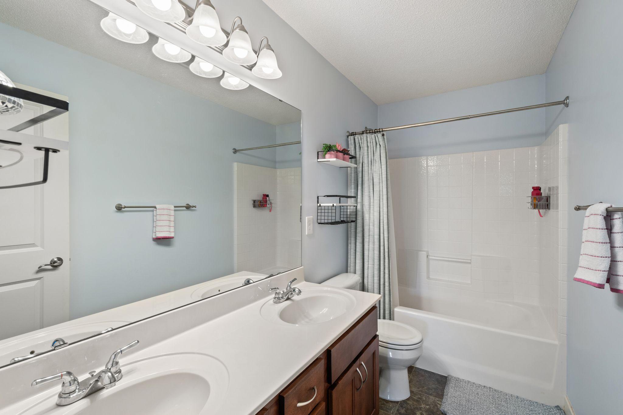 A second full bathroom upstairs with double sinks.