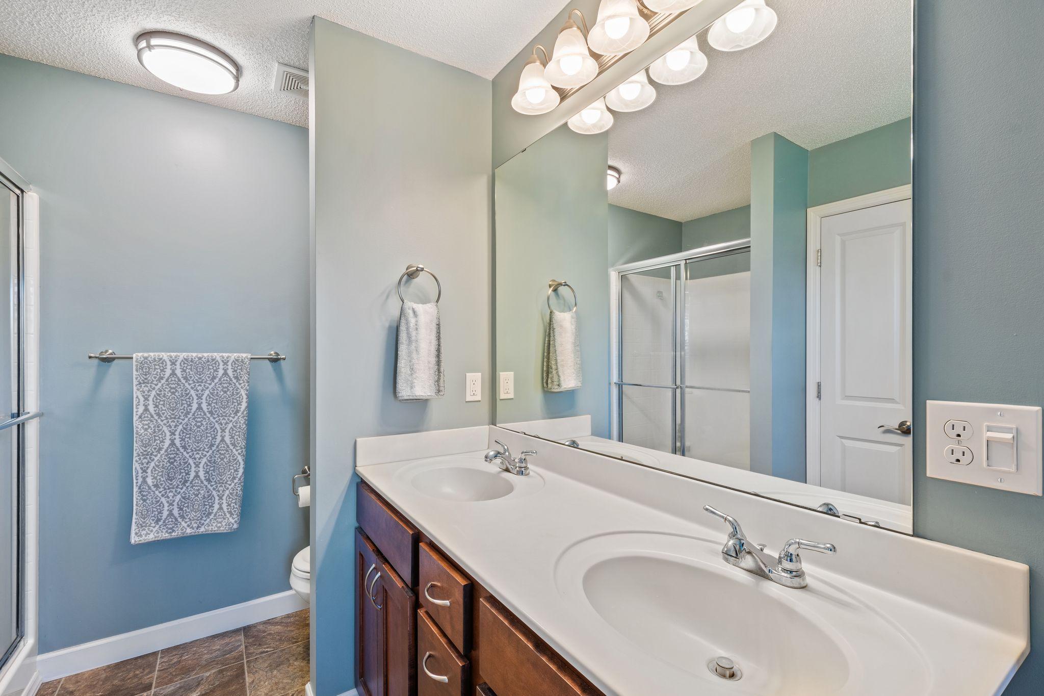 Double vanities and a separate walk-in shower.