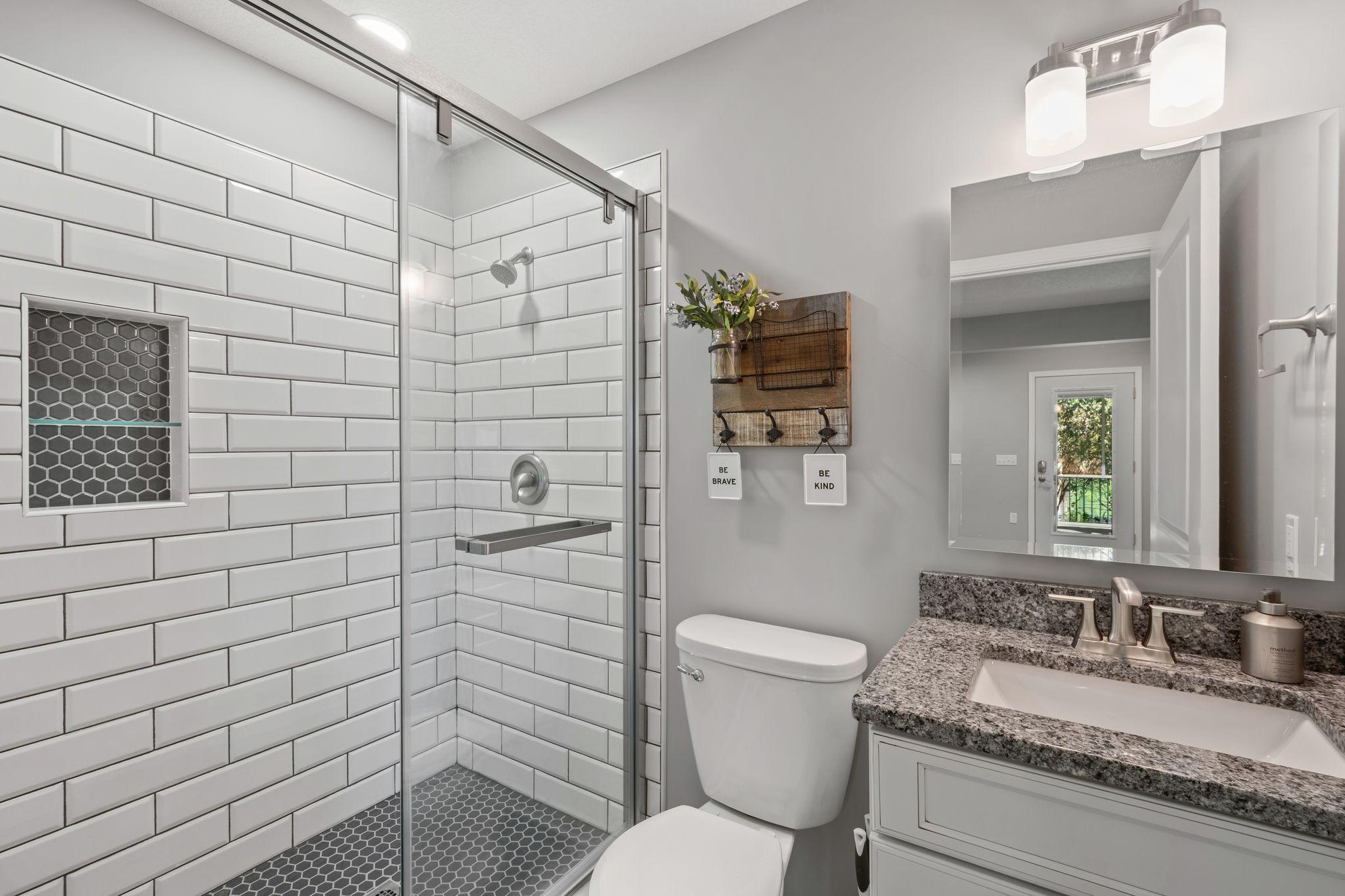 A beautifully finished 3/4 bathroom with tiled shower are sure to impress.