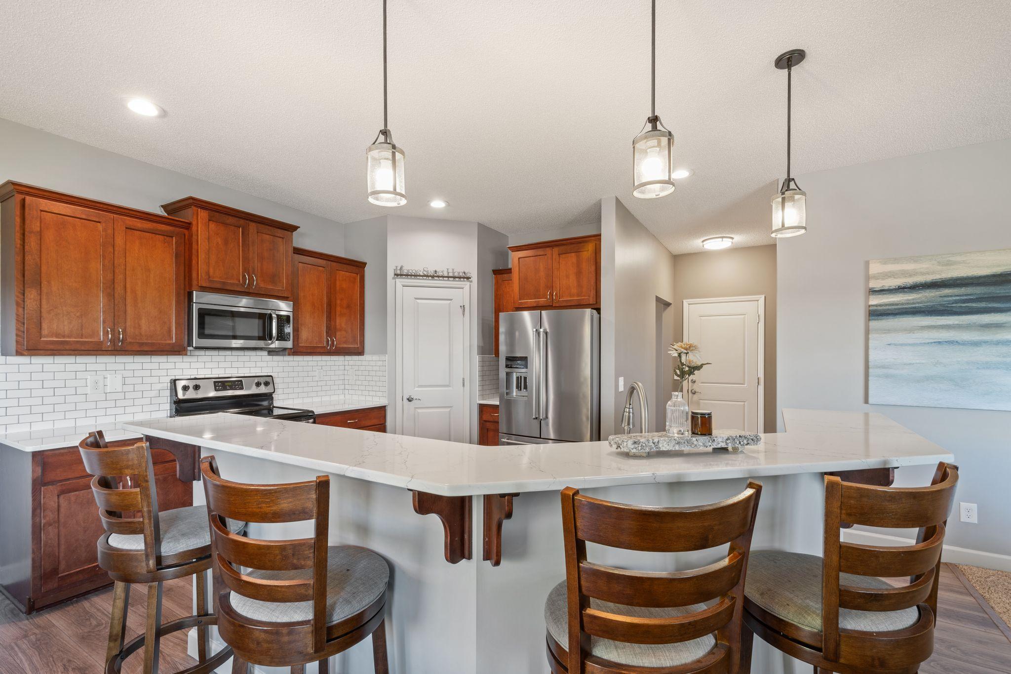 A tile backsplash and walk in pantry complete the space.