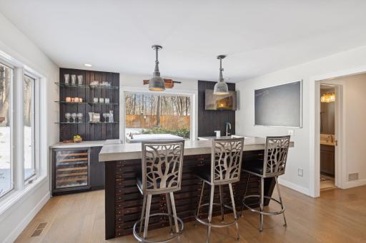 Main level wet bar with wine refrigerator.