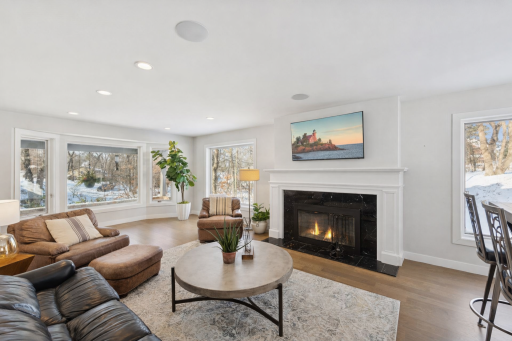 ***Fireplace mantel is currently a natural wood tone. The mantel in this image has been AI modified to envision what it could look like if painted. This is a wood burning fireplace.