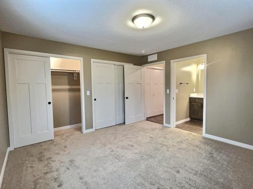 The primary bedroom will have a private bath and dual closets and is on the back side of the home. Photo is from a previous model.