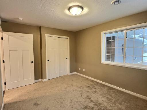 Front bedroom for guests, home office or your flex room to use as you chose. Photo is from a previous model.