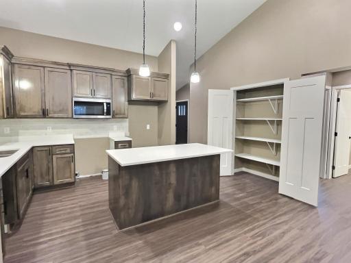 The pantry is conveniently located off the kitchen and offers ample shelving for storing you kitchen accessories and goods. Photo is from a previous model.