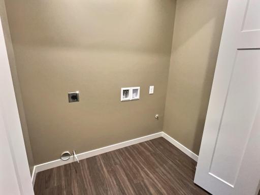 The laundry room is nicely located between the 2 bedrooms. Photo is from a previous model.